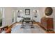 Well-lit study with fireplace, built-in shelving, hardwood floors and glass desk at 5750 Hemby Rd, Matthews, NC 28104