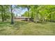 Backyard features mature trees providing shade and privacy, perfect for relaxation and outdoor activities at 600 Community Ln, Lancaster, SC 29720