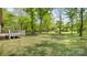 Expansive backyard with mature trees and a wood deck, offering privacy and space for outdoor activities at 600 Community Ln, Lancaster, SC 29720