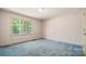 Carpeted bedroom with view of trees outside at 600 Community Ln, Lancaster, SC 29720