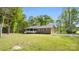 Exterior view of brick house with a well-maintained yard and attached garage nestled among lush trees at 600 Community Ln, Lancaster, SC 29720