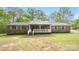 Charming brick home featuring a covered front porch and a well-maintained front yard with mature trees at 600 Community Ln, Lancaster, SC 29720