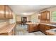 Kitchen with wood cabinets adjoins the dining area with hutch and table at 600 Community Ln, Lancaster, SC 29720