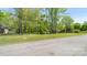 Street view of the property with a large grassy front yard and mature trees providing shade and curb appeal at 600 Community Ln, Lancaster, SC 29720