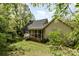 Lush backyard featuring a screened porch, mature trees, and a well-maintained lawn at 608 Grace St, Shelby, NC 28150
