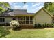 Backyard with a screened porch, lush greenery, and well-maintained lawn at 608 Grace St, Shelby, NC 28150