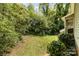 Backyard featuring a screened porch and mature trees with a well-maintained lawn at 608 Grace St, Shelby, NC 28150