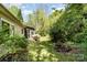 Lush backyard with a screened porch, mature trees, and a well-maintained lawn at 608 Grace St, Shelby, NC 28150