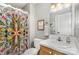 Cozy bathroom with colorful shower curtain, white vanity and toilet at 608 Grace St, Shelby, NC 28150