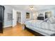 Bedroom with hardwood floors, large bed, with doorway leading to hallway and bathroom at 608 Grace St, Shelby, NC 28150