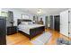 Comfortable bedroom with a large bed, hardwood floors, soft rug and neutral-toned walls and curtains at 608 Grace St, Shelby, NC 28150