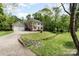 View of the exterior featuring an attached two-car garage, driveway, manicured lawn and mature landscaping at 608 Grace St, Shelby, NC 28150
