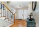 View of the foyer with hardwood floors, staircase with white risers and light wood handrail at 608 Grace St, Shelby, NC 28150