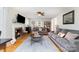 Cozy living room with a brick fireplace, hardwood floors, neutral paint, and comfortable gray sofas at 608 Grace St, Shelby, NC 28150
