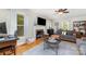 Inviting living room with large windows, fireplace, flat-screen TV, and hardwood floors at 608 Grace St, Shelby, NC 28150