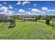 Spacious backyard with playground and a large brick home at 610 Blaise Ct, Matthews, NC 28104