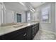 Spacious bathroom features double sinks, granite counters, black cabinetry, and modern fixtures at 610 Blaise Ct, Matthews, NC 28104
