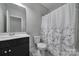 Small bathroom featuring toilet, sink, vanity, and shower at 610 Blaise Ct, Matthews, NC 28104