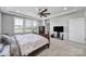 Large bedroom boasts neutral walls, large windows, and a beautiful ceiling fan at 610 Blaise Ct, Matthews, NC 28104