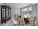 Formally staged dining room showcasing elegant glass table, neutral chairs, and a vintage china cabinet at 610 Blaise Ct, Matthews, NC 28104