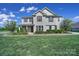 Charming two-story home with a well-manicured lawn and inviting front porch, exuding curb appeal at 610 Blaise Ct, Matthews, NC 28104