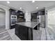 Spacious kitchen with dark cabinets, stainless steel appliances, granite counters and a large center island at 610 Blaise Ct, Matthews, NC 28104