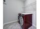 Spacious laundry room with shelving and red, front-loading washer and dryer at 610 Blaise Ct, Matthews, NC 28104
