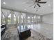 Bright living room with ceiling fan, large windows, and access to outdoor space at 610 Blaise Ct, Matthews, NC 28104