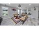 Cozy living room featuring stylish seating, decorative rug, and plantation shutters providing lots of natural light at 610 Blaise Ct, Matthews, NC 28104