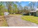 Wide driveway extends to backyard area, and side of home with carport at 612 Rowan Mill Rd, Salisbury, NC 28147