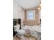 A well-lit bathroom with a toilet, sink, and bathtub at 612 Rowan Mill Rd, Salisbury, NC 28147