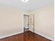 Bedroom featuring neutral walls, hardwood floors, and unique vintage-style door at 612 Rowan Mill Rd, Salisbury, NC 28147