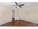 Bedroom featuring hardwood floors, a ceiling fan, and neutral color palette at 612 Rowan Mill Rd, Salisbury, NC 28147