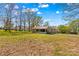 Charming single-story home with a metal roof, covered porch, and a grassy yard, complemented by a bright blue sky at 612 Rowan Mill Rd, Salisbury, NC 28147