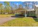Home exterior showing the large carport, well-maintained lawn, and driveway at 612 Rowan Mill Rd, Salisbury, NC 28147