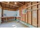 Interior of unfinished garage featuring exposed framing, workbench, and storage space at 612 Rowan Mill Rd, Salisbury, NC 28147