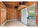 Unfinished garage interior with open door leading to carport, and exposed wooden framework at 612 Rowan Mill Rd, Salisbury, NC 28147
