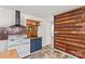 An alternate view of the kitchen with white appliances, and wood accent wall at 612 Rowan Mill Rd, Salisbury, NC 28147
