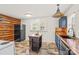 Charming kitchen with wood accent wall, unique tile backsplash, black appliances, and a butcher block island at 612 Rowan Mill Rd, Salisbury, NC 28147