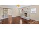 Cozy living room featuring hardwood floors, a brick fireplace, and sliding barn doors at 612 Rowan Mill Rd, Salisbury, NC 28147