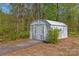 Metal shed and driveway extending into the property's wooded backyard at 612 Rowan Mill Rd, Salisbury, NC 28147