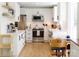 Bright kitchen with white cabinets, stainless steel appliances, and wood-look flooring at 6718 Rollingridge Dr, Charlotte, NC 28211