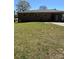 View of the back of the brick home, showing the lawn and covered parking area at 736 Lawndale Cir, Fort Lawn, SC 29714