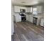This modern kitchen features stainless steel appliances, white cabinets, and laminate floors at 736 Lawndale Cir, Fort Lawn, SC 29714