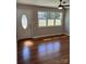 Bright living room with hardwood floors, modern ceiling fan, and large windows that flood the space with natural light at 736 Lawndale Cir, Fort Lawn, SC 29714