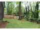 Relax in the expansive backyard with a charming swing set, mature trees, and lush green lawn at 7626 Surreywood Pl, Charlotte, NC 28270