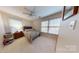 Bedroom featuring a bed and two windows, illuminated by natural light at 7626 Surreywood Pl, Charlotte, NC 28270