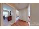 Hallway with hardwood style floors and white doors leading into multiple rooms create an inviting transition between spaces at 7626 Surreywood Pl, Charlotte, NC 28270