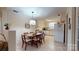 Bright kitchen with white appliances, tile flooring, dining area, and plenty of natural light at 7626 Surreywood Pl, Charlotte, NC 28270