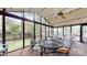 Spacious screened porch perfect for outdoor dining, featuring ample seating, a ceiling fan, and views of the green yard at 7626 Surreywood Pl, Charlotte, NC 28270